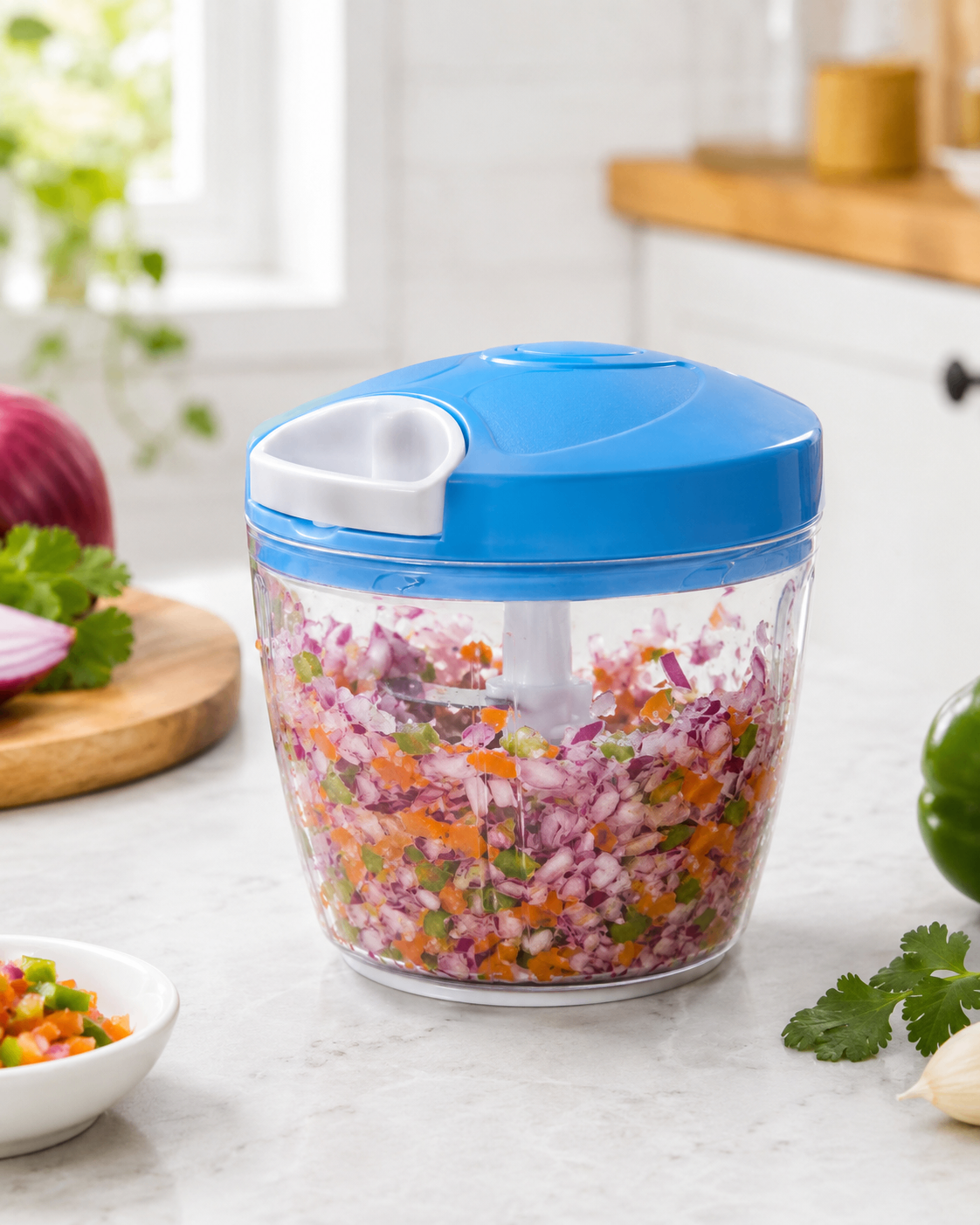 Blue 500 ML manual food chopper filled with chopped vegetables on a counter